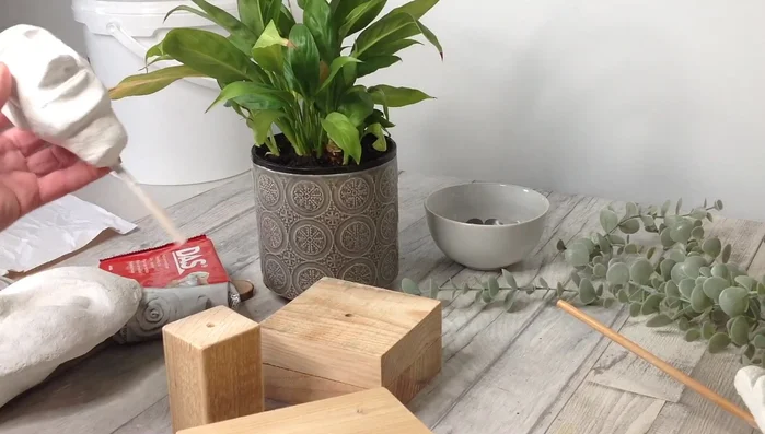 Once dry, paint, varnish, or leave the sculpture as is. For display, create a stand using wood blocks, drilling holes and attaching them with glue.