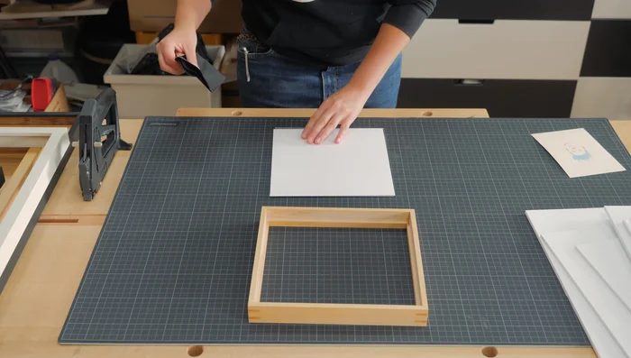 Install sawtooth hangers and silicone bumpers.