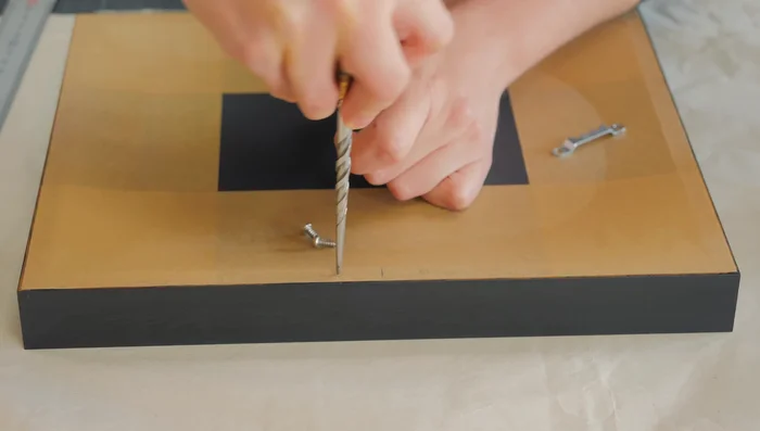 Install sawtooth hangers and silicone bumpers.