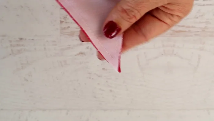 Trim excess fabric at the point to prevent bunching, then turn inside out.