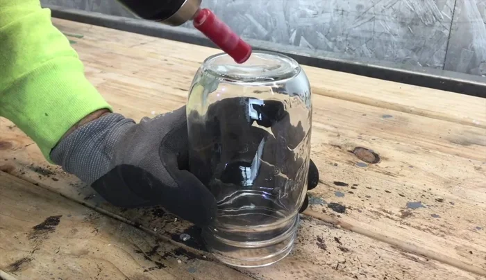 Drill a hole in the center of the bottom of each mason jar using a ¼ inch glass cutting drill bit. Lubricate the bit with water to prevent breakage and protect the bit.