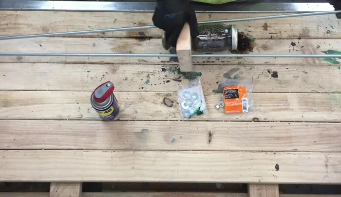 Place a nut and screw on each end of the through-rods. Slide the planters onto the rods, tightening the nuts. Use WD40 for easier threading if needed.