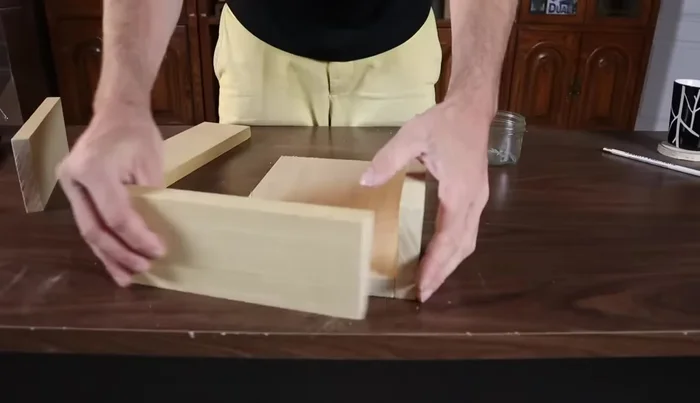 Assemble the box: First, attach the sides to the base using nails. Pre-set nails slightly above the bottom edge (3/8 inch) for secure attachment.