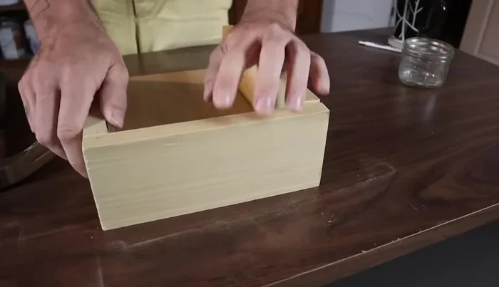 Attach the ends: Nail the bottom of each end first, then adjust and nail the top, ensuring a flush fit with the sides.