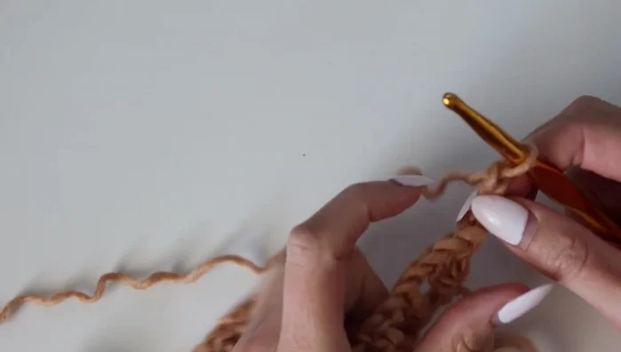 Row 2: Chain 3, turn. Work 2 double crochets in the same stitch as the last double crochet of the previous row. Continue with double crochet in the chain 1 space, double crochet in the next stitch. Repeat across, performing decreases at the bottom of each ripple.