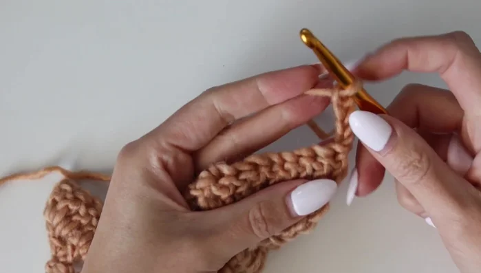 Row 3: Chain 4 (counts as dc + ch-1), turn. Work 1 double crochet in the same stitch. Repeat chain 1, skip, double crochet sequence. Perform decreases at the bottom of each ripple. At the peak of each ripple, chain 3 and work 2 double crochets into the same stitch.