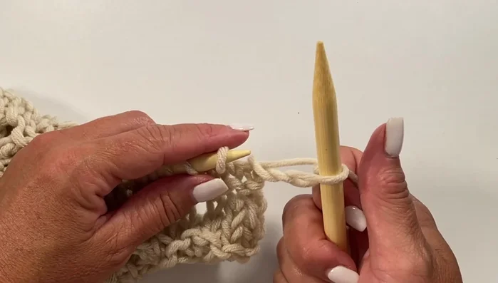 Row 23: Knit three, knit one, yarn over, knit one (all in the next stitch), knit three, repeat across, knit one.