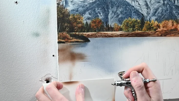 Use a ruler for perfectly horizontal lines when erasing ripples, keeping the water surface flat. 