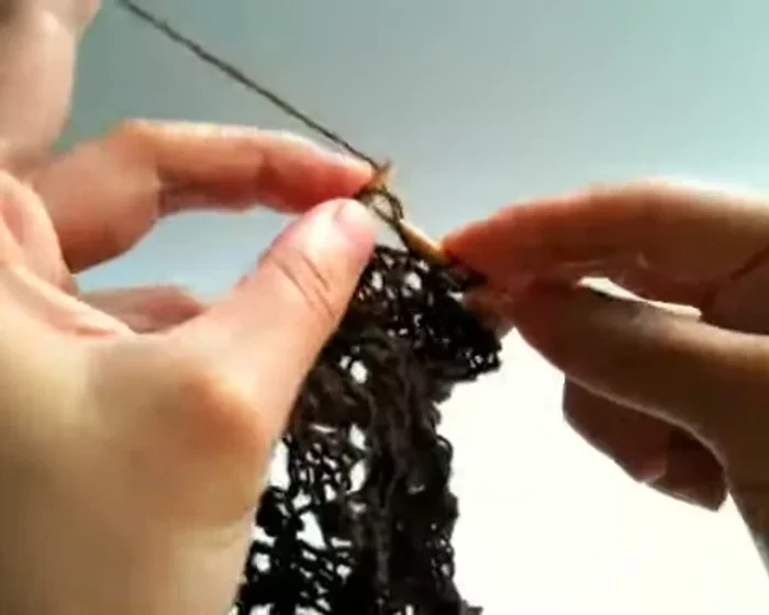 Knit three, purl one (over two yarn overs from previous row), knit two.