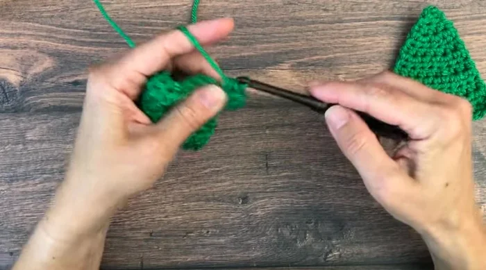 Final increase row: Chain one, half double crochet in first stitch, increase in next stitch, half double crochet in each stitch until two stitches remain, final increase in the second to last stitch, one half double crochet in the last stitch (total 12 stitches).