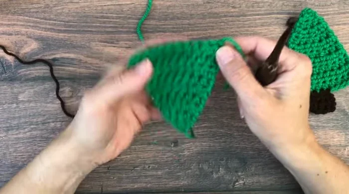 Turn, chain one, and half double crochet in each of the next three stitches to complete the trunk.