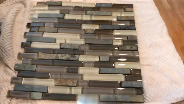 Cut the mesh backing of the tile to separate sections for easier installation around outlets and switches.