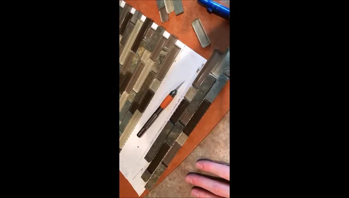 Install the top row, possibly trimming pieces to achieve the desired fit and spacing. Pay attention to starting and stopping points to avoid excessive cutting of small pieces.