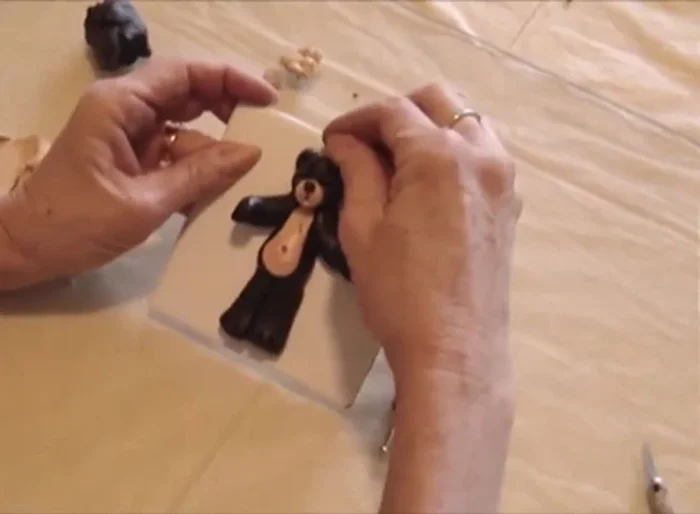 Insert cut paper clips as hooks for hanging. Apply super glue to secure the hooks before baking.