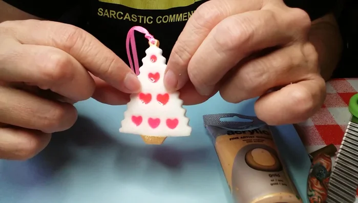 Apply glaze and attach ribbon for hanging.