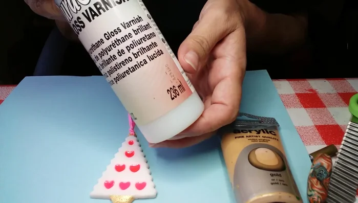 Apply glaze and attach ribbon for hanging.