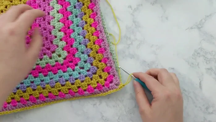 Insert pillow form: Insert the pillow form into the open side of the cover.