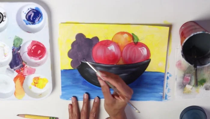 Darken areas between the fruits to enhance depth. Add a shadow under the bowl with a darker shade of blue to ground it.