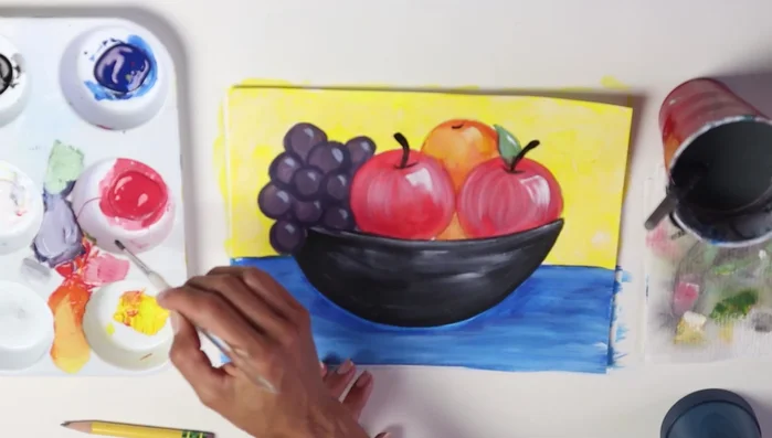 Darken areas between the fruits to enhance depth. Add a shadow under the bowl with a darker shade of blue to ground it.