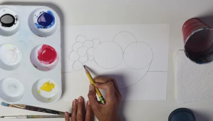 Draw a line across to represent the top of the bowl, overlapping with fruits. Erase any lines under the bowl line.