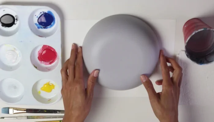 Draw a line across to represent the top of the bowl, overlapping with fruits. Erase any lines under the bowl line.