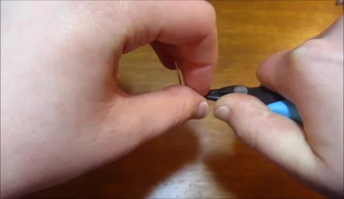 Bend the long tail to create a curve, then trim and secure the end.