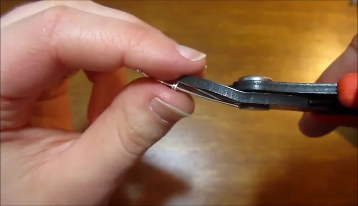 Bend the long tail to create a curve, then trim and secure the end.