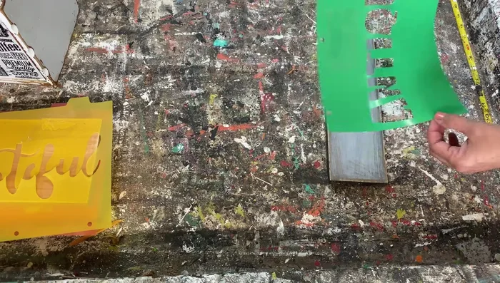 Carefully peel off the stencil while the paint is still wet to avoid smearing.