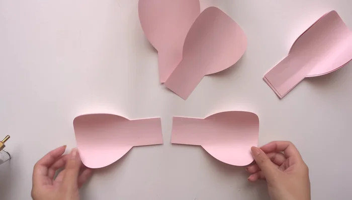 Assemble the bud: Glue pairs of bud petals together, then cross the pairs and glue them together to create a layered bud center. Repeat with the remaining bud petals.