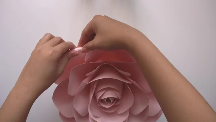 Optional finishing touch: Curl the edges of the petals using a thin pen or pencil to add detail and enhance the flower's appearance.
