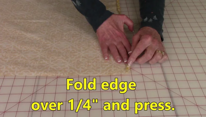 Fold over the center edge of each back piece 1/4 inch, press, fold again 1/4 inch and press. Stitch close to the folded edge on both pieces.