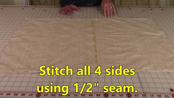 Stitch a 1/2 inch seam around all four sides. Double stitch along the center back seam where the back pieces overlap for added strength.