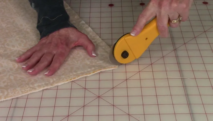 Trim the excess fabric from the corners, leaving about 1/8 inch. Turn the sham right side out, and poke out the corners using your fingers. Insert the pillow.