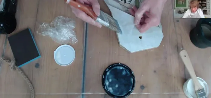 Apply a top coat of decoupage medium to seal the paper.