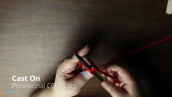 Provisional cast on 15 stitches using crochet hook, scrap yarn, and one knitting needle.