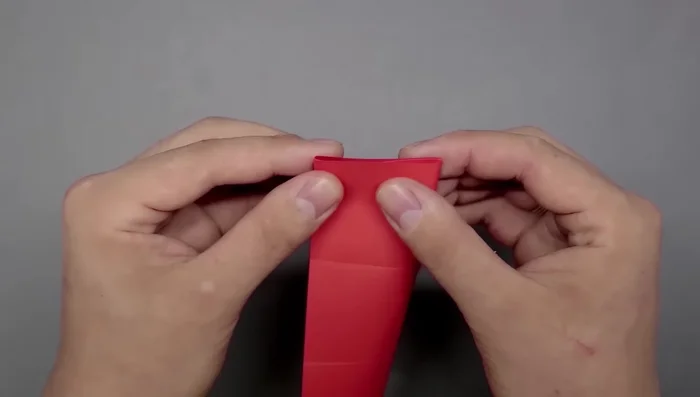 Fold along the newly created creases to divide the paper into nine smaller squares.