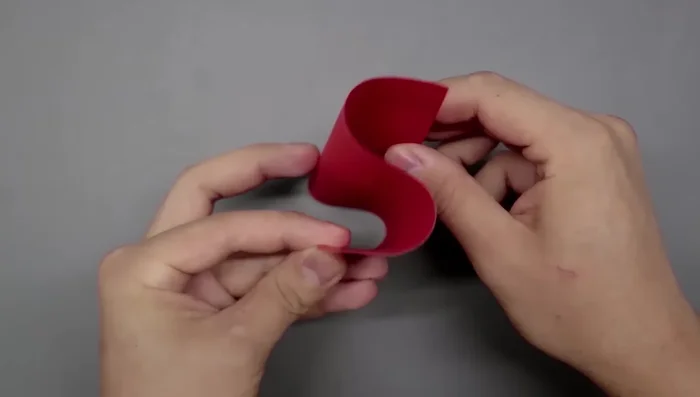 Rotate the square and divide it into thirds again, using the same 'S' curve and crease method as before.