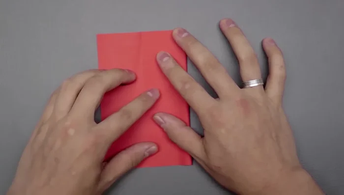 Rotate the square and divide it into thirds again, using the same 'S' curve and crease method as before.