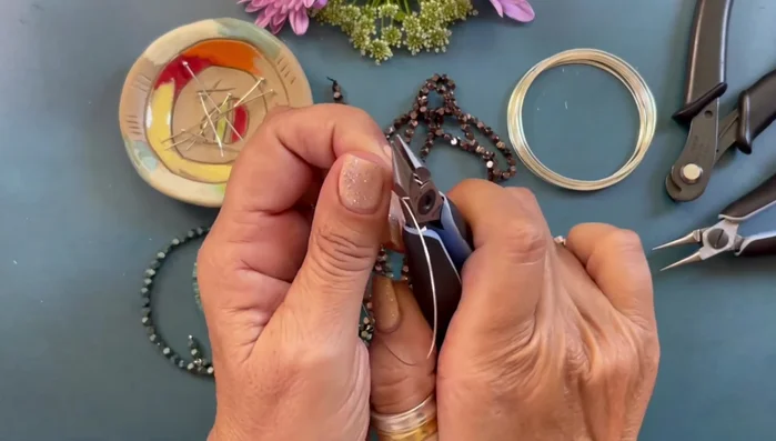 Use round nose pliers to neatly roll and secure the loop.