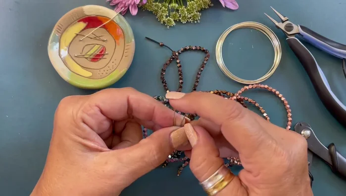 Attach the dangles to the bracelet by opening and closing the loops.