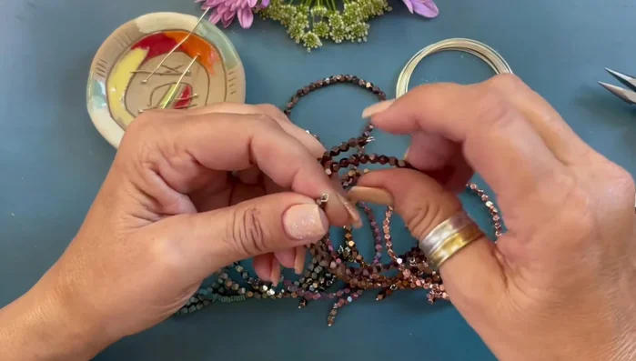 Attach the dangles to the bracelet by opening and closing the loops.