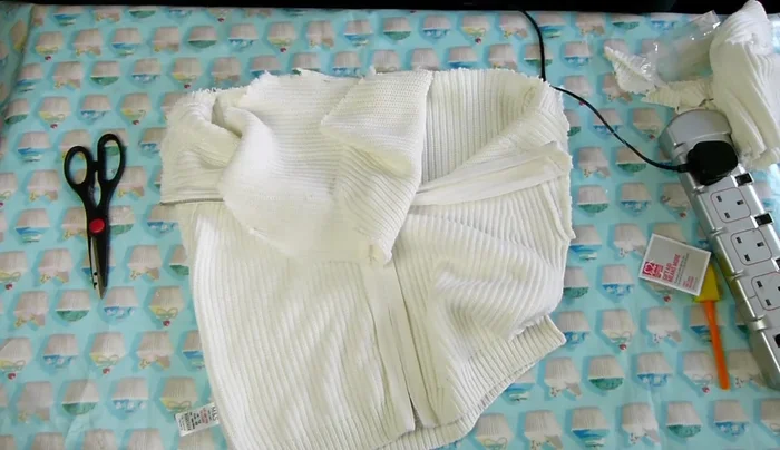 Glue the bottom base (created in step 7) to the frayed edges of the jumper's bottom, all the way around.