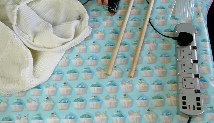 Glue wooden dowels to the bottom and sides of the basket for structural support.