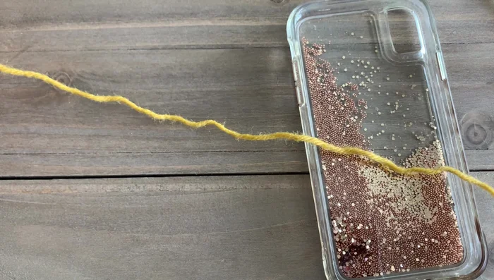 Attach tassels to the corners of the blanket using a crochet hook, weaving in the ends.