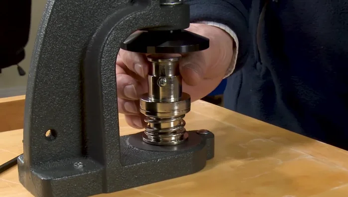 Place the top die upside down on the bottom die. Depress the lever with medium to light pressure.