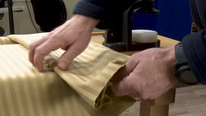 Use the hole cutter to create a hole in the center of the fabric circle.