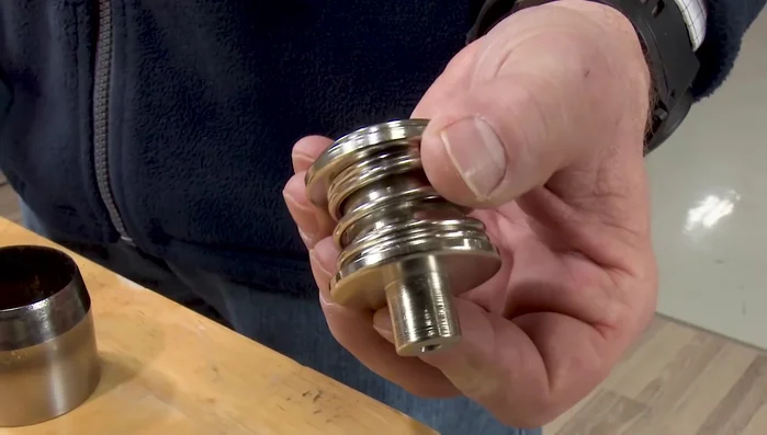 Install the spring-loaded bottom die into the W One hand press.