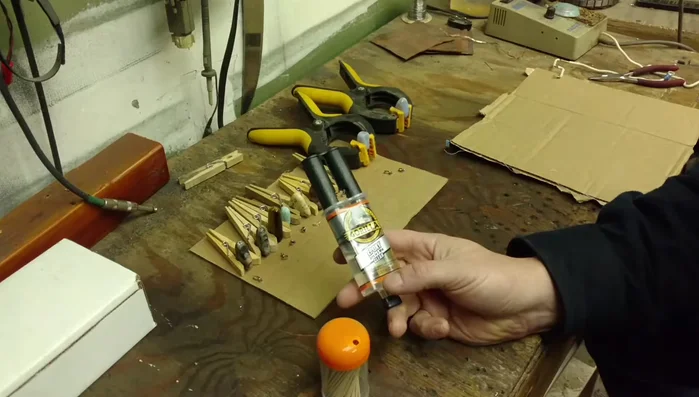 Apply two-part epoxy to attach the bails to the drilled holes in the stones.