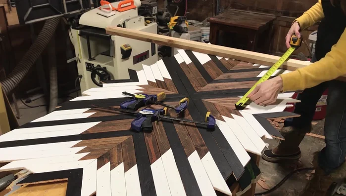 Cut the edges of the sign, ensuring accuracy by measuring from the middle and following the pattern.