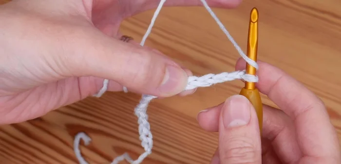 Skip the next two chains. In the third chain, repeat step 4 (2 trebles, chain one, 2 trebles).